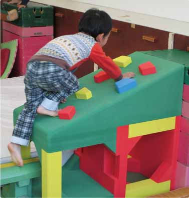 Child playing on soft play equipment (Ibaraki Plant)
