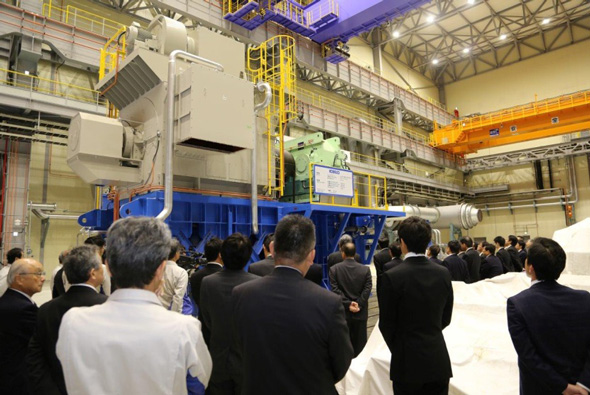 Participants at the opening ceremony view a large-capacity compressor ready to under testing.