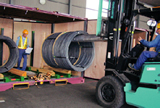 Loading wire rod into a container