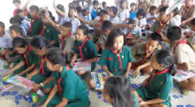 Children receiving donated stationery supplies