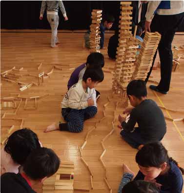 Children building a town from wooden blocks (Shinko Kenzai)